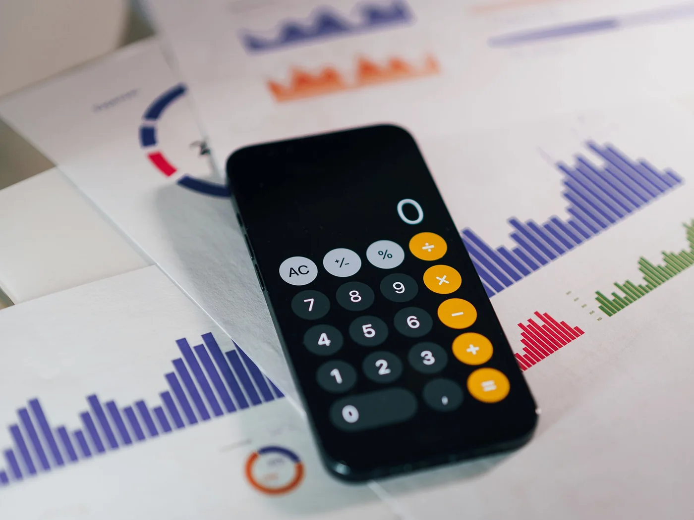 Calculator and financial charts representing rental-property coverage analysis