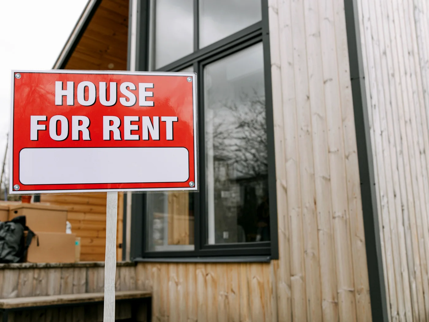 Rental home with a house-for-rent sign representing DSCR investor financing