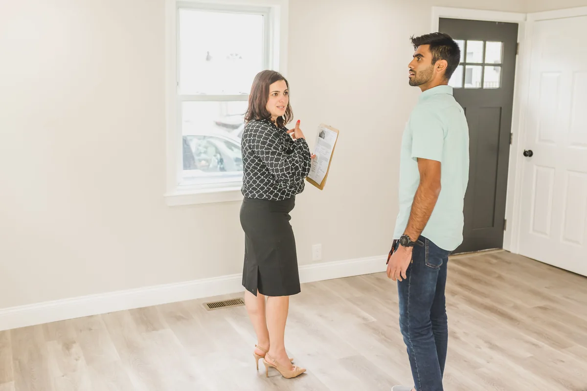 Investor touring a modern rental property with a real estate professional